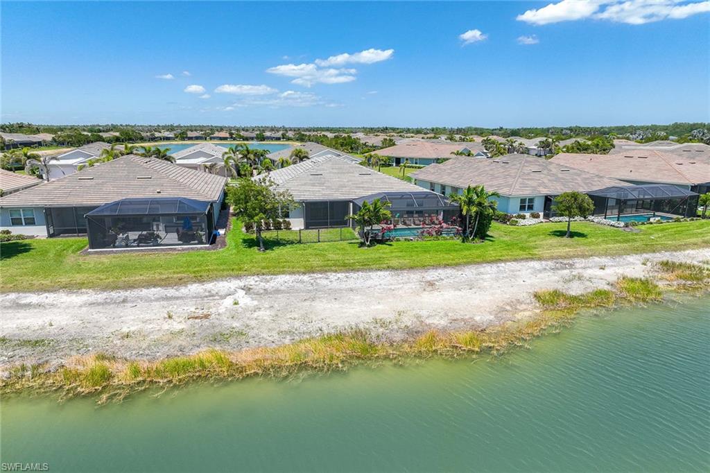 14799 Edgewater Circle Naples, FL 34114 - Photo 26 of 35 a view of a house with a yard and lake view