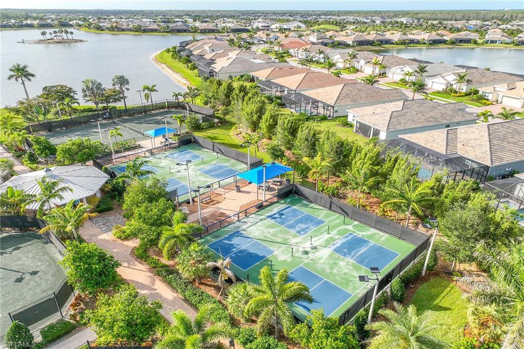 14799 Edgewater Circle Naples, FL 34114 - Photo 30 of 35 an aerial view of residential houses with outdoor space and swimming pool