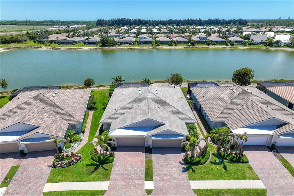 14799 Edgewater Circle Naples, FL 34114 - Photo 3 of 35 an aerial view of a house with a lake view