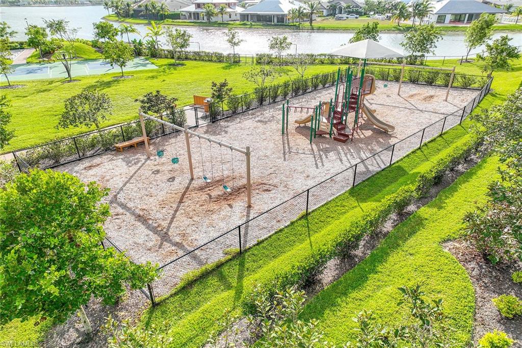 14799 Edgewater Circle Naples, FL 34114 - Photo 31 of 35 a view of swimming pool with outdoor seating and lake