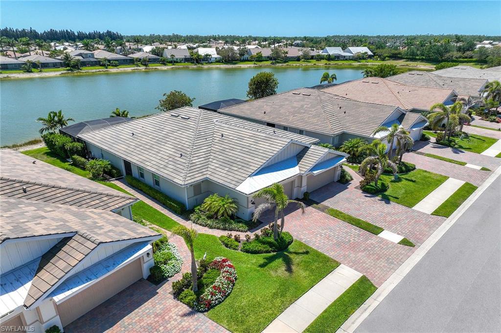 14799 Edgewater Circle Naples, FL 34114 - Photo 4 of 35 an aerial view of a house with outdoor space and lake view