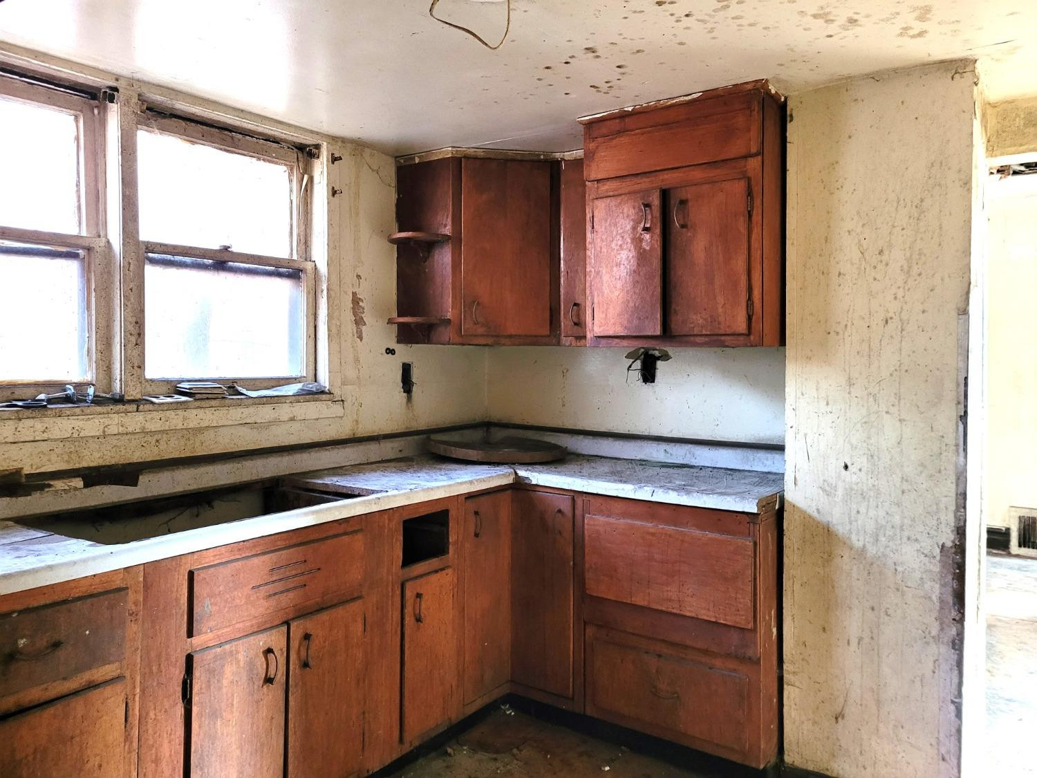 1736 Fillmore Street Gary, IN 46407 - Photo 5 of 14 a kitchen with granite countertop a sink cabinets and window