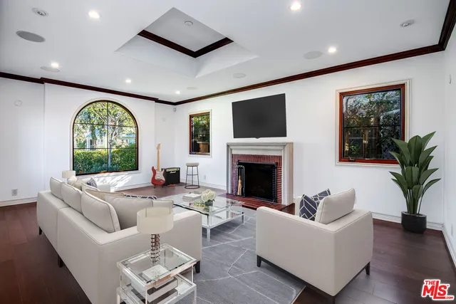 a living room with fireplace furniture and a large window