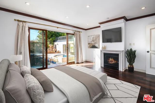 a spacious bedroom with a large bed and a fireplace