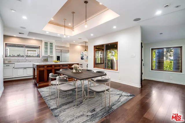 a dining room with furniture and wooden floor