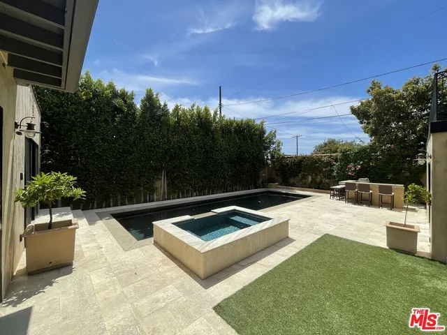 a view of a backyard with sitting area
