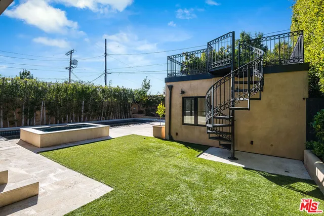 a view of a swimming pool with couches in patio