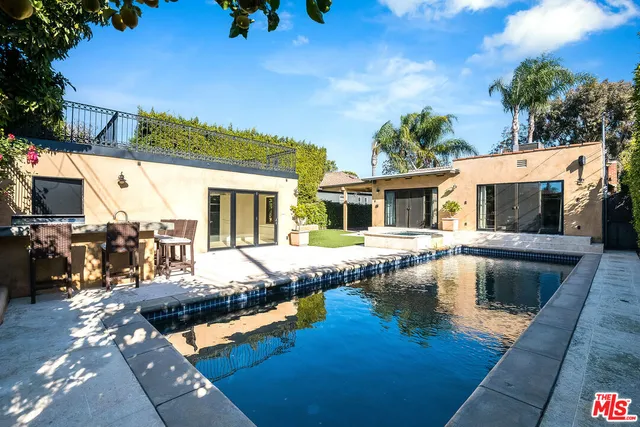 a view of house with swimming pool outdoor seating
