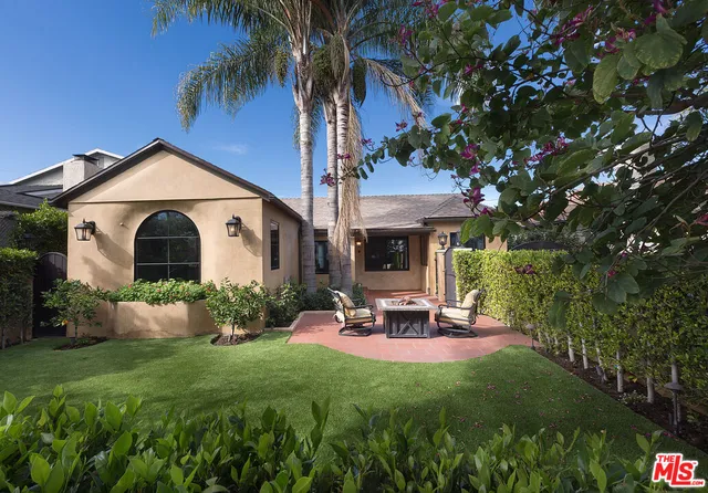 a front view of a house with a garden and patio