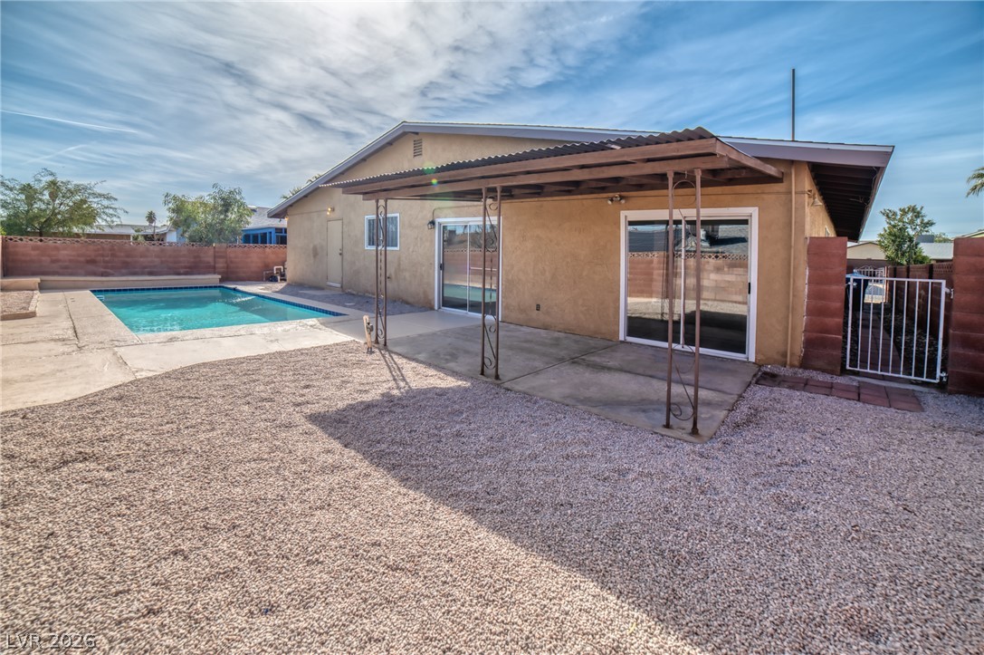 3556 Ruth Drive Las Vegas, NV 89121 - Photo 18 of 21 The backyard oasis features a glistening pool and a shaded patio area, perfect for outdoor enjoyment.