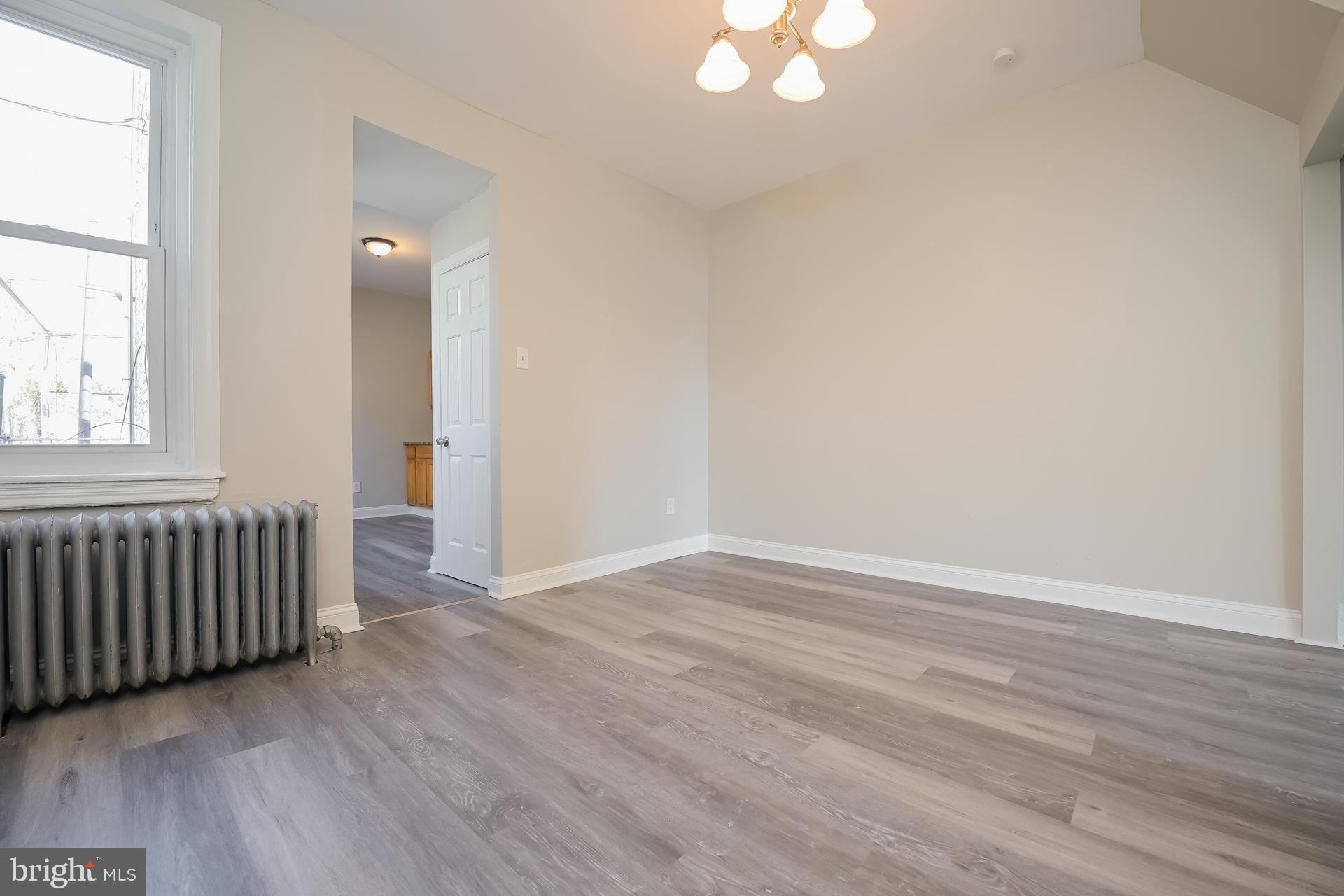2629 North 34th Street Philadelphia, PA 19132 - Photo 4 of 10 an empty room with wooden floor and windows