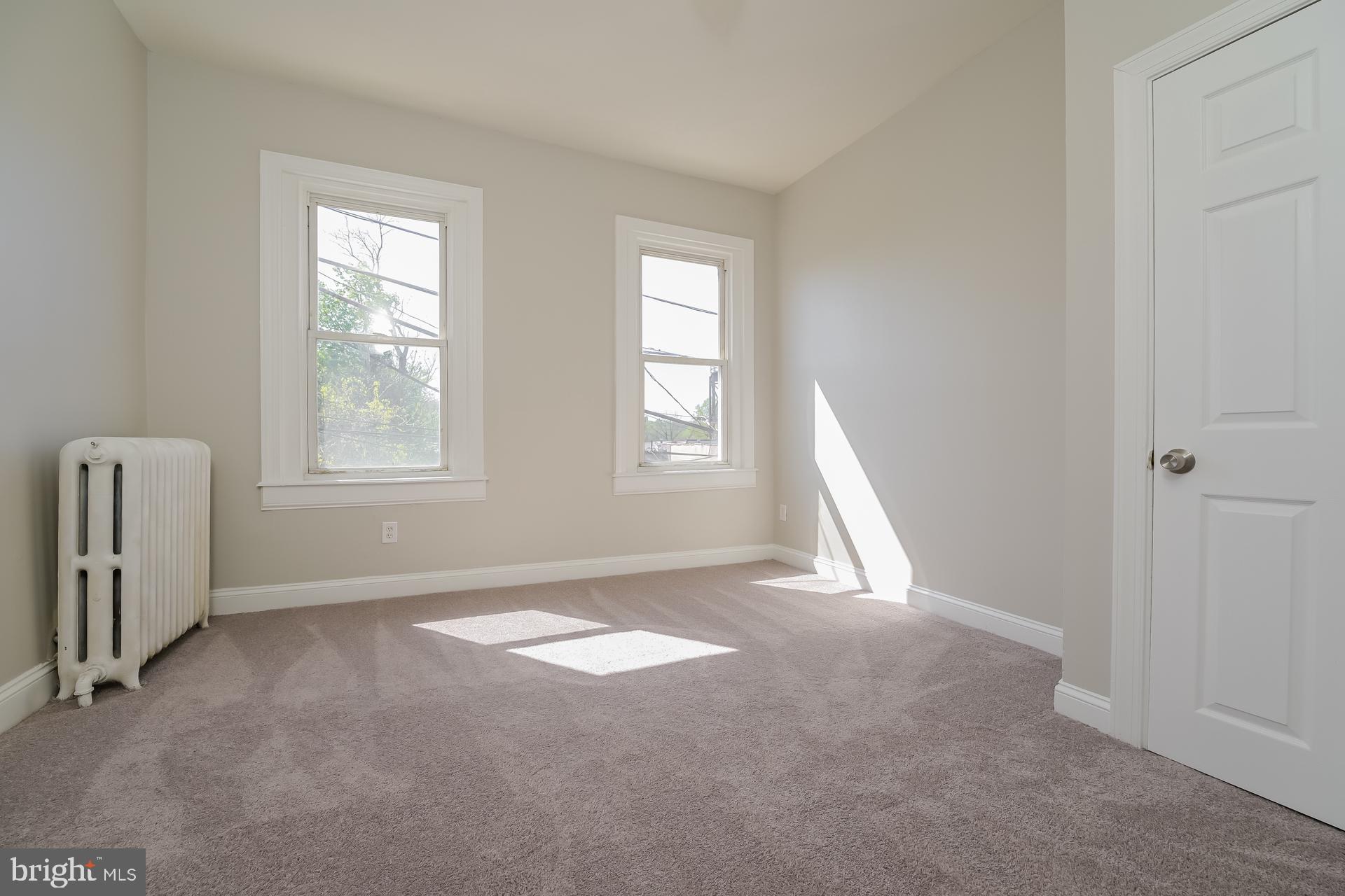 2629 North 34th Street Philadelphia, PA 19132 - Photo 6 of 10 an empty room with windows