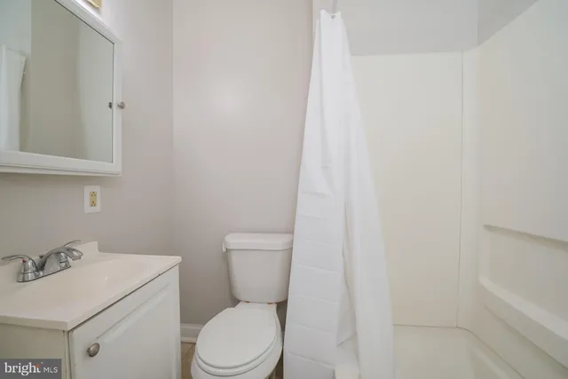 a white toilet sitting next to a white sink
