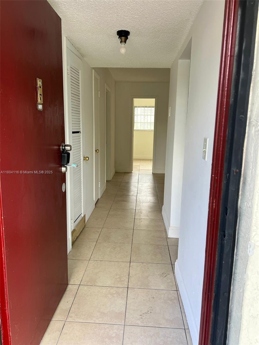 220 Southwest 9th Avenue, Unit 117 Hallandale Beach, FL 33009 - Photo 14 of 14 a view of a hallway with windows