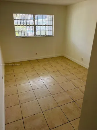 a bathroom with a granite countertop bathtub sink vanity mirror and toilet