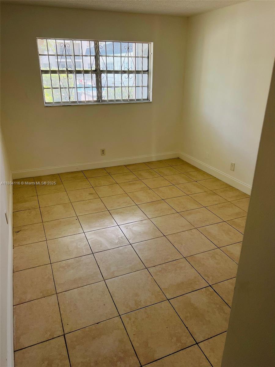 220 Southwest 9th Avenue, Unit 117 Hallandale Beach, FL 33009 - Photo 5 of 14 a view of a room and window