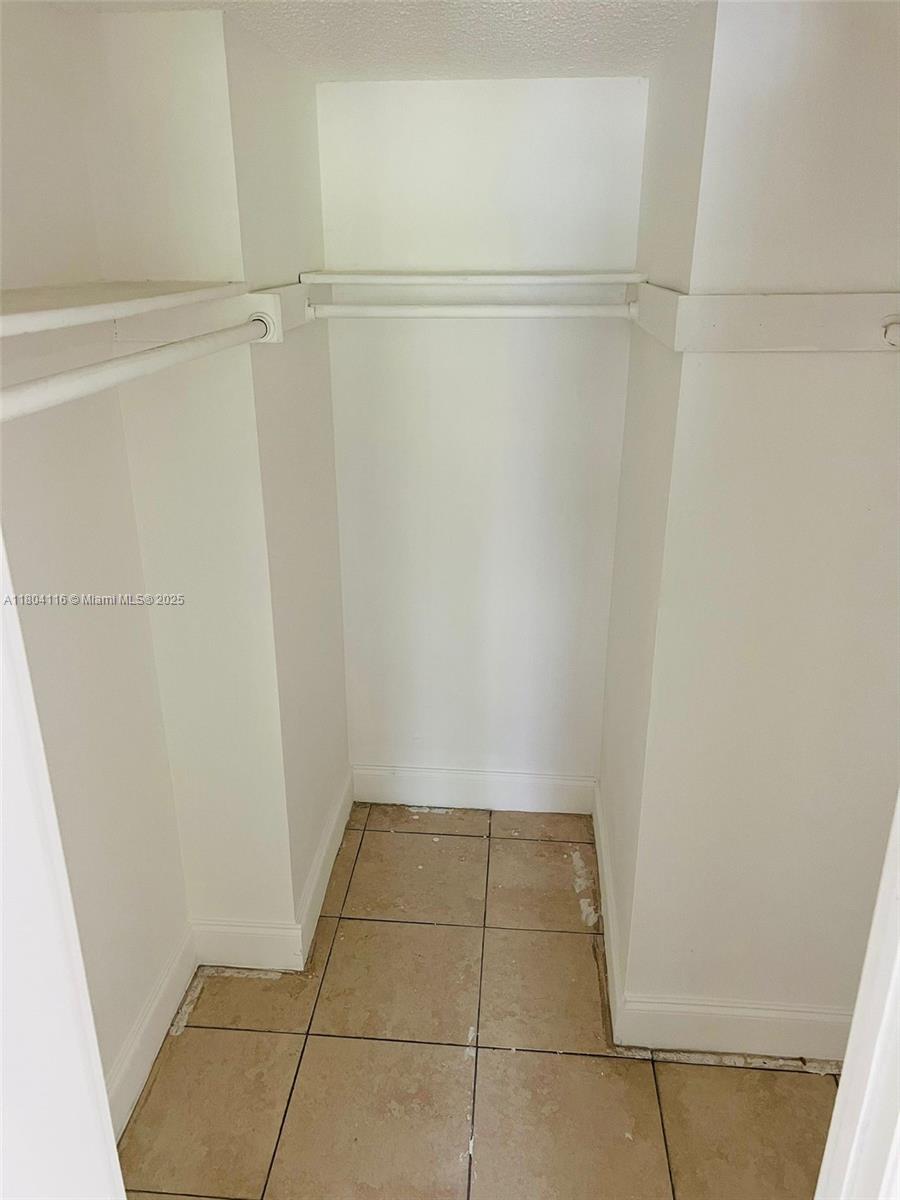 220 Southwest 9th Avenue, Unit 117 Hallandale Beach, FL 33009 - Photo 7 of 14 a view of an empty walk in closet