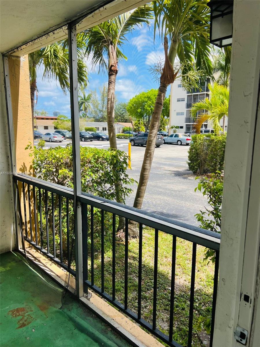 220 Southwest 9th Avenue, Unit 117 Hallandale Beach, FL 33009 - Photo 10 of 14 a view of balcony with wooden floor