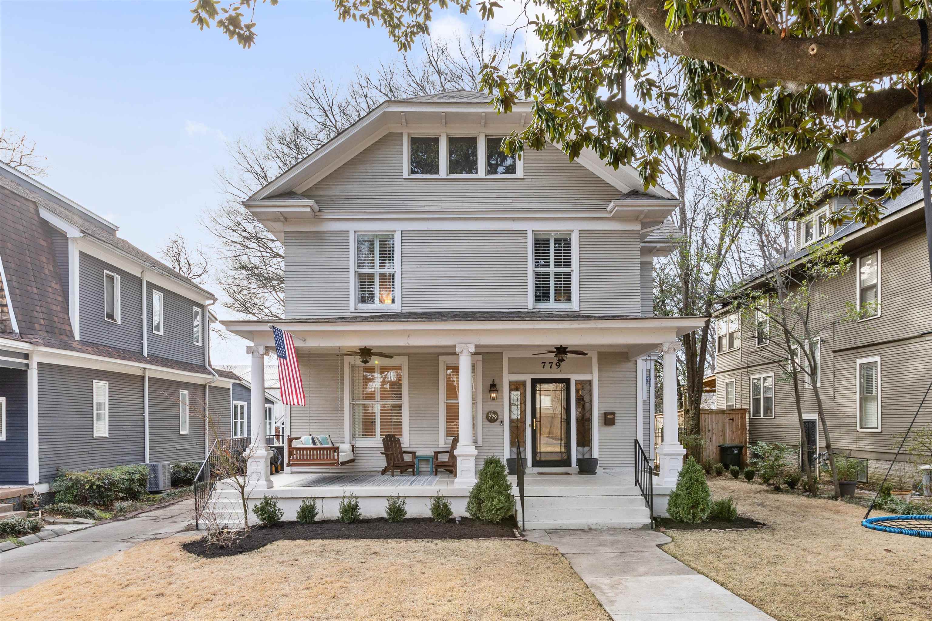 a front view of a house with yard porch and furniture