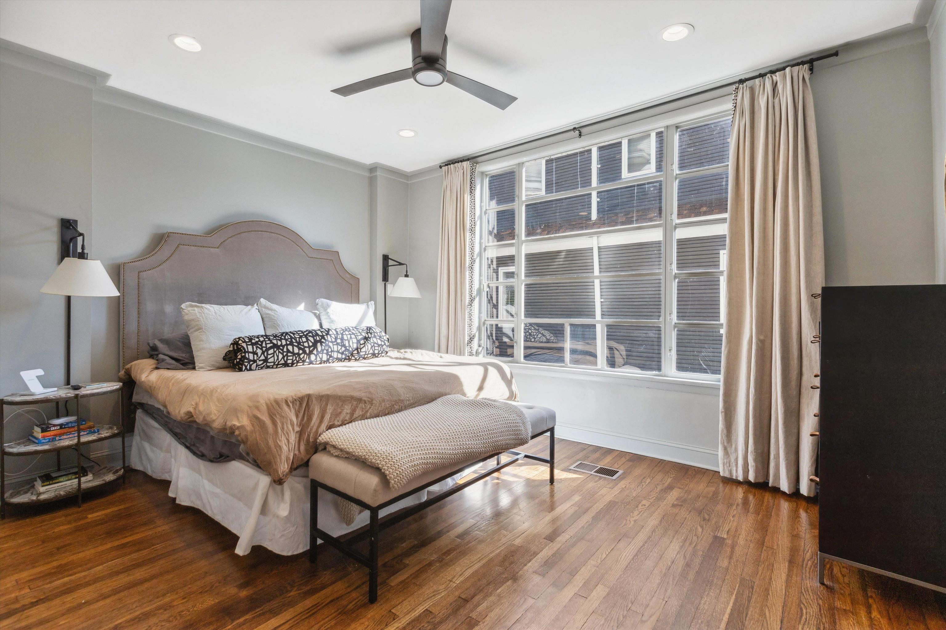 779 Roland Street Memphis, TN 38104 - Photo 13 of 29 a spacious bedroom with a bed and wooden floor