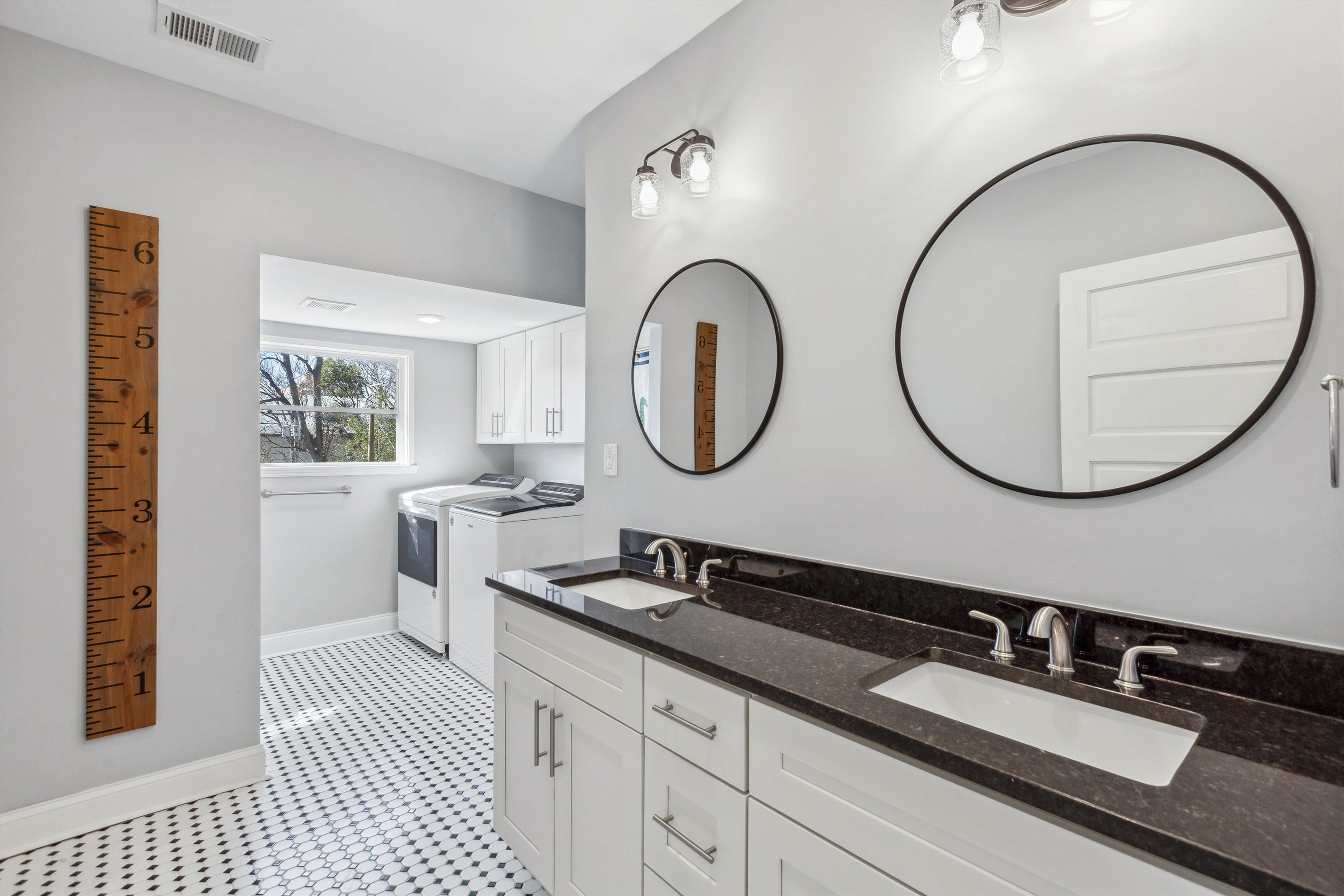 779 Roland Street Memphis, TN 38104 - Photo 19 of 29 a bathroom with a double vanity sink and a mirror