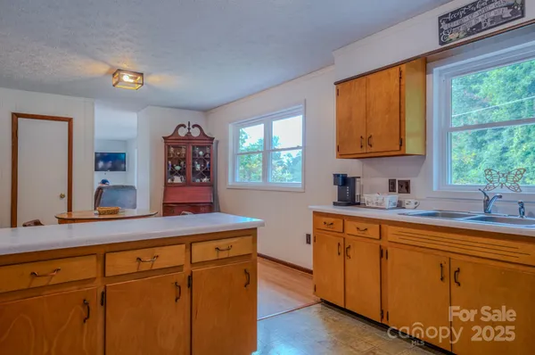 a kitchen with cabinets a window and a sink