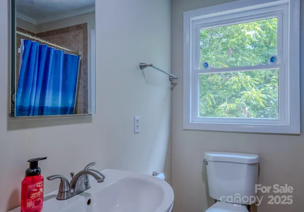 a bathroom with a toilet sink and mirror