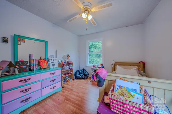 a bed room with a bed and a dresser