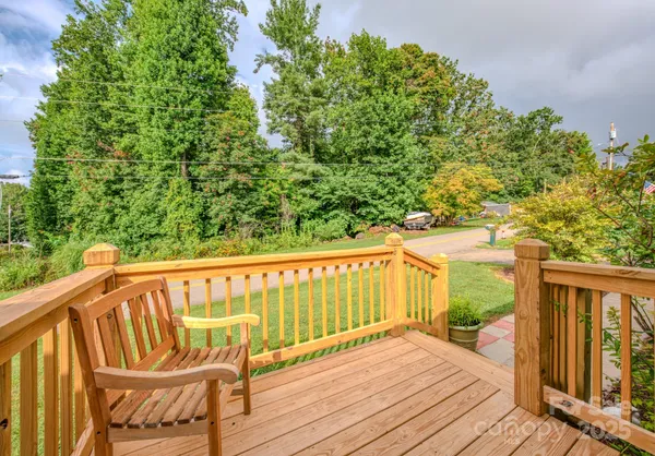 a view of a wooden deck with a yard