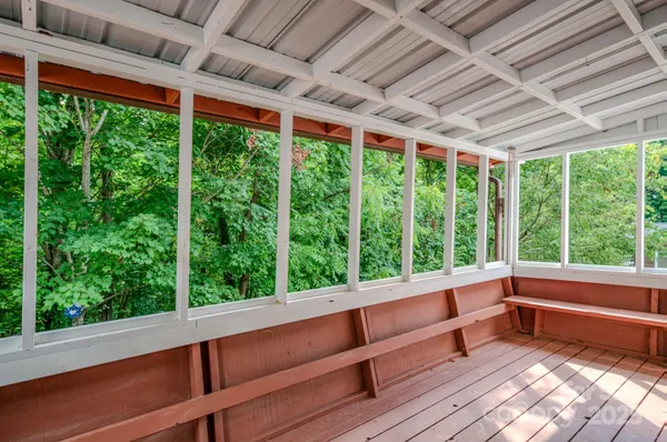 a view of a room with large trees and outdoor space