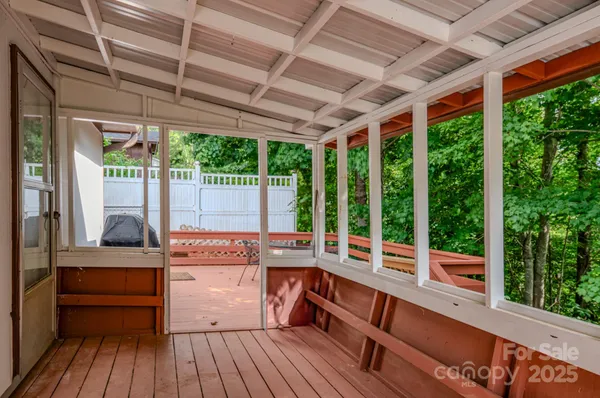 a view of a room with wooden floor and outdoor seating