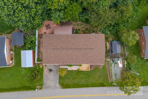 an aerial view of a house with a yard