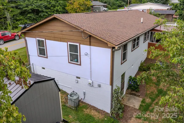 an aerial view of a house with a yard