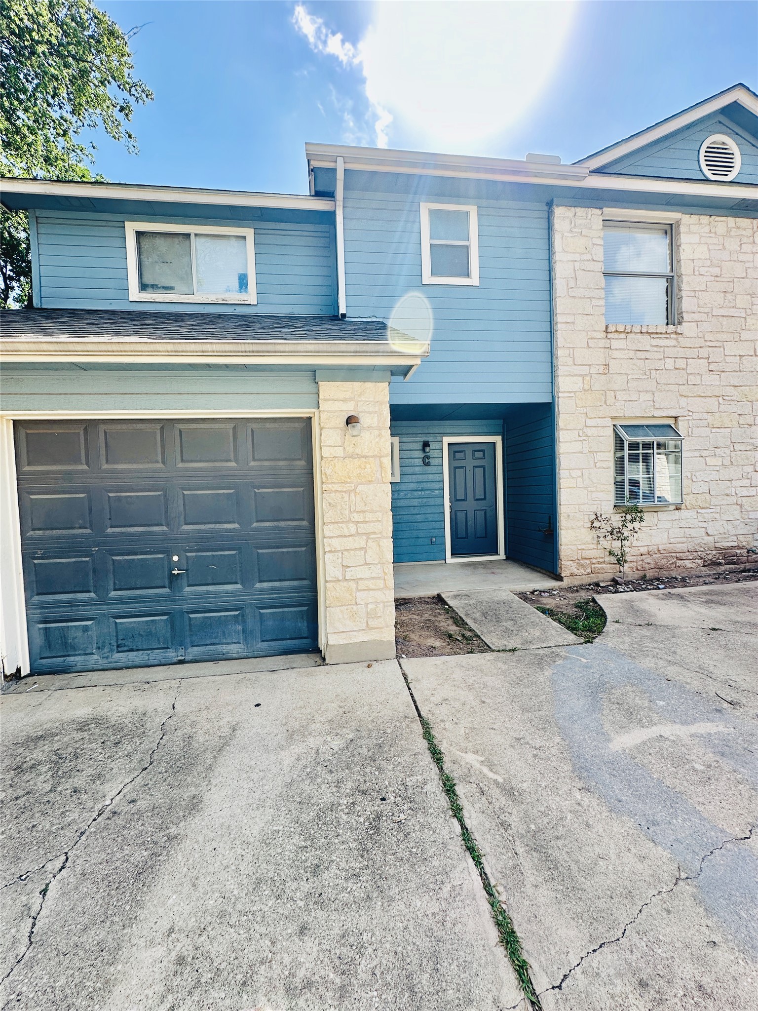 8814 Schick Road, Unit C Austin, TX 78729 - Photo 1 of 35 A welcoming façade blends blue siding and stone accents for appealing curb appeal.