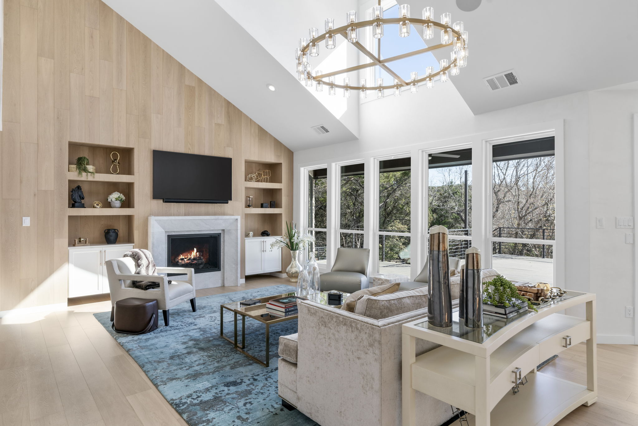 701 Furlong Drive Austin, TX 78746 - Photo 1 of 40 a living room with furniture a fireplace and a flat screen tv