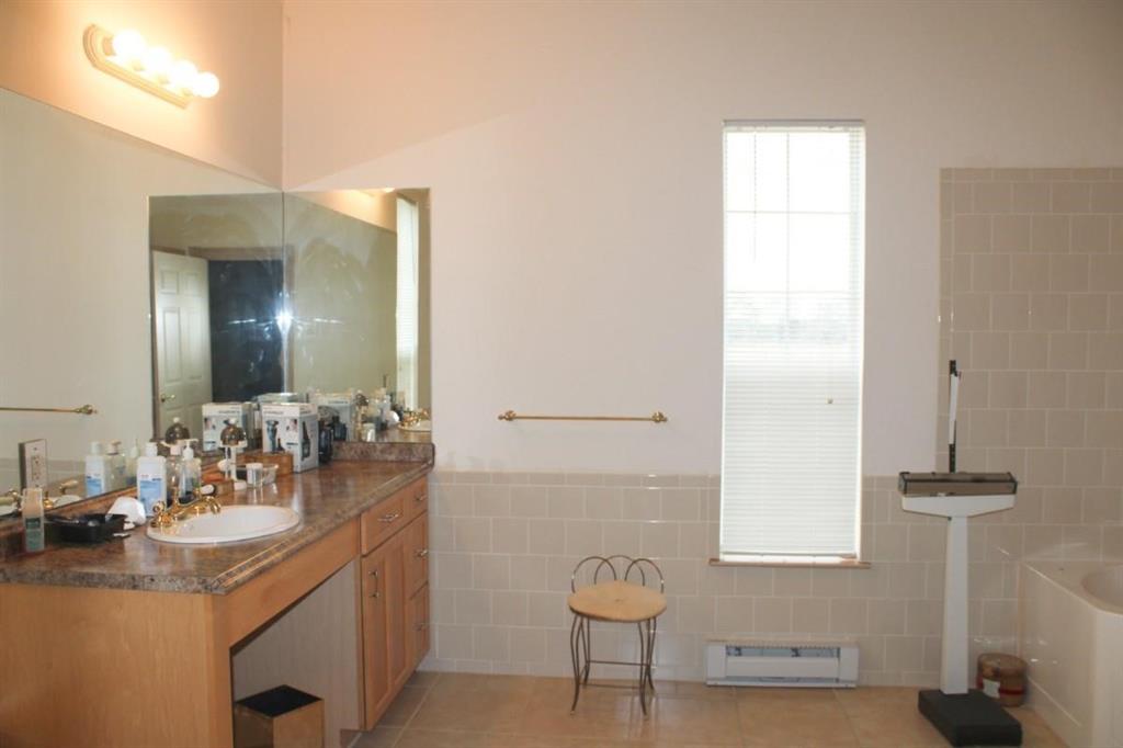 1365 Signal Road Quinlan, TX 75474 - Photo 14 of 33 a bathroom with a sink and a mirror