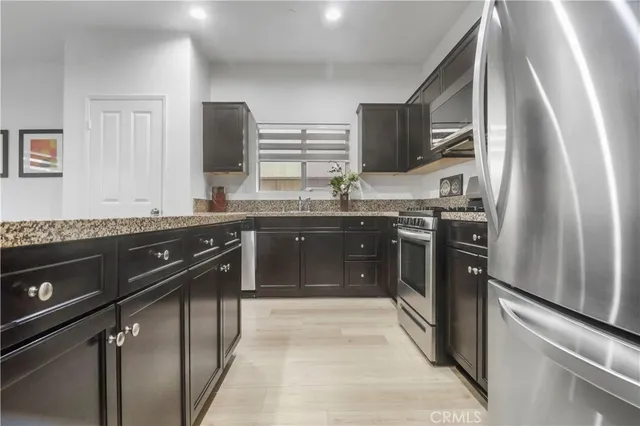 a kitchen with a sink stove and cabinets