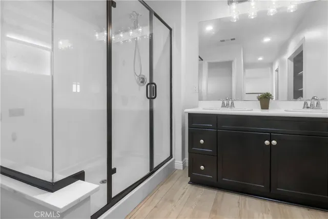 a bathroom with a double vanity sink and mirror