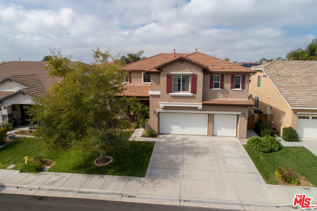 6847 Raspberry Court Eastvale, CA 92880 - Photo 2 of 49 a front view of a house with a garden