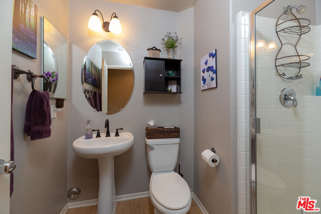 6847 Raspberry Court Eastvale, CA 92880 - Photo 23 of 49 a bathroom with a toilet sink and mirror
