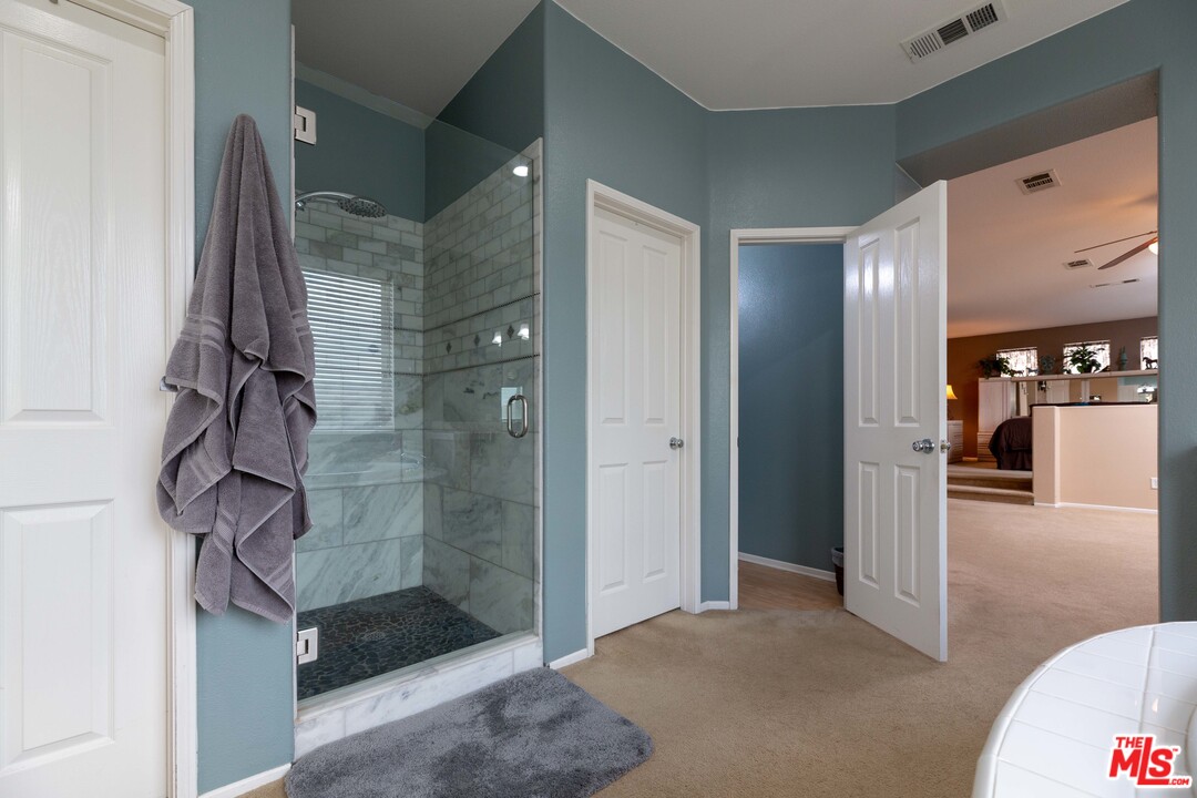 6847 Raspberry Court Eastvale, CA 92880 - Photo 33 of 49 a bathroom with a shower and a sink