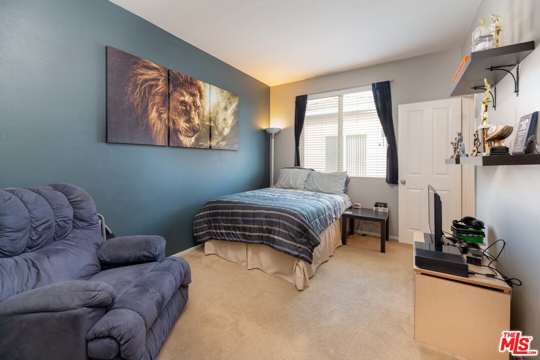 6847 Raspberry Court Eastvale, CA 92880 - Photo 36 of 49 a bedroom with a bed and a large window