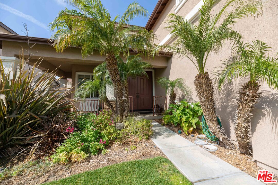 6847 Raspberry Court Eastvale, CA 92880 - Photo 6 of 49 a front view of a house with a yard