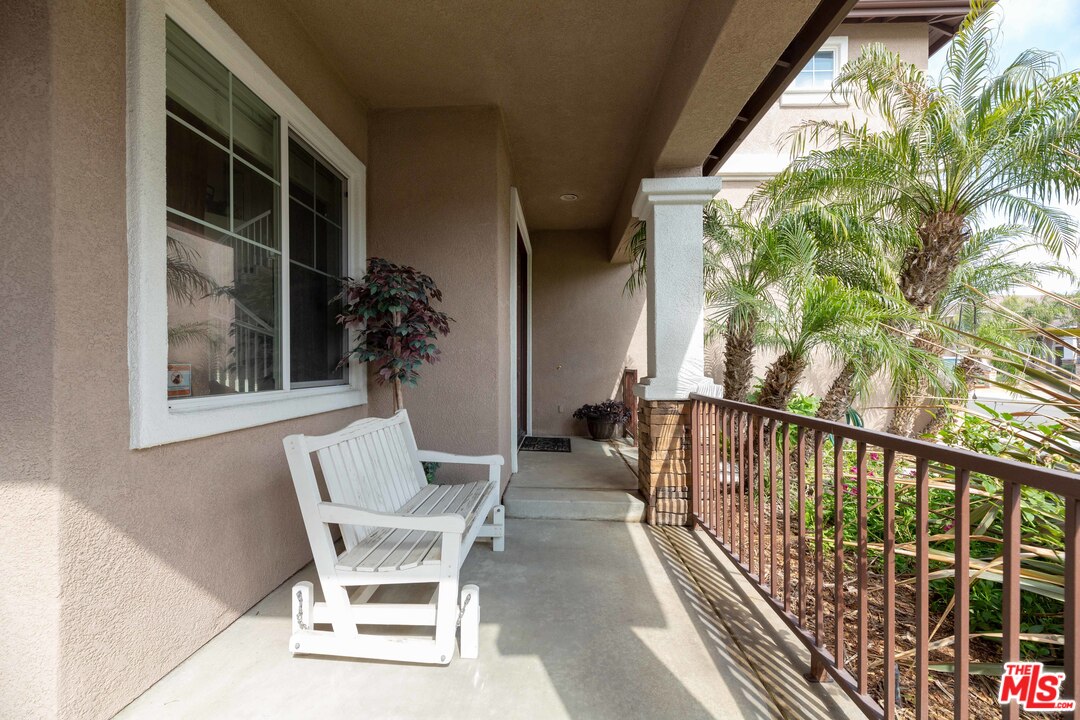 6847 Raspberry Court Eastvale, CA 92880 - Photo 7 of 49 a balcony with table and chairs