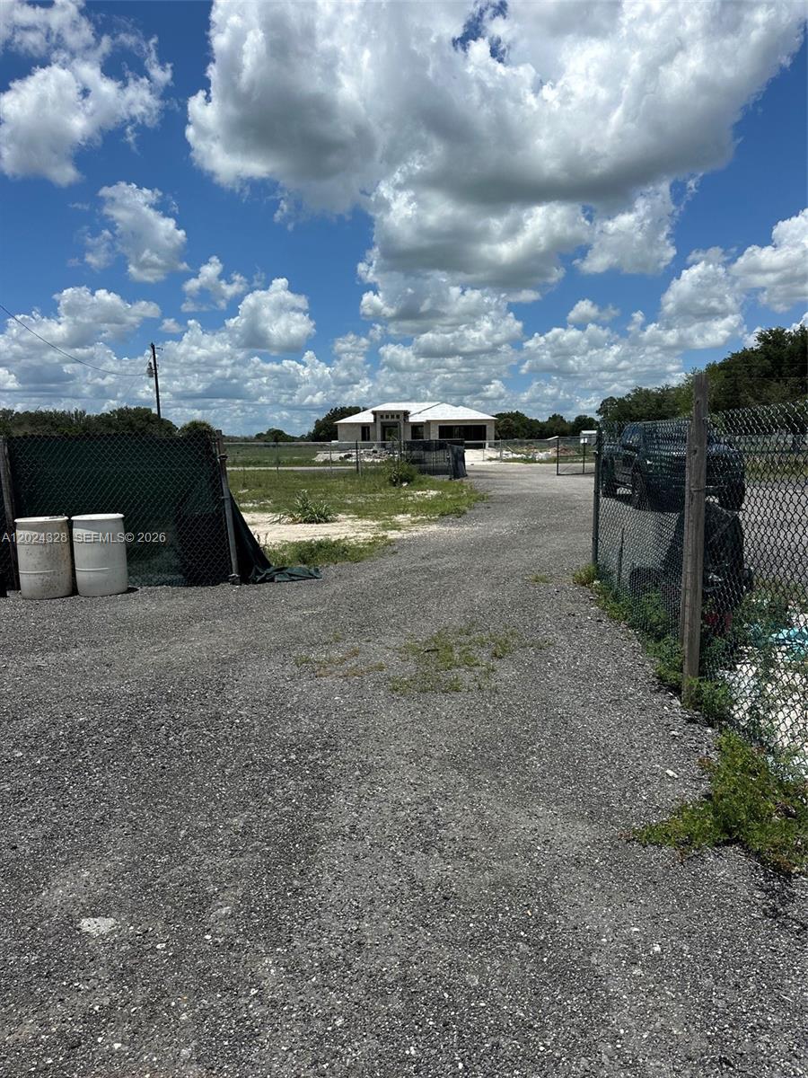 625 North Quebrada Street Clewiston, FL 33440 - Photo 22 of 26 a view of a lake with an outdoor space