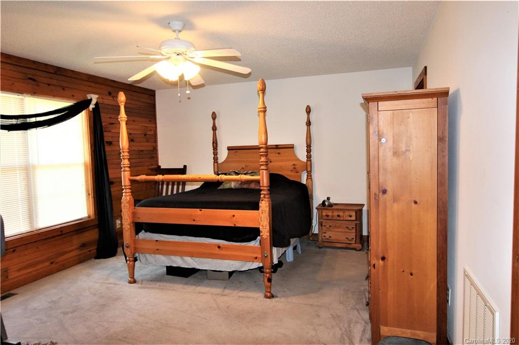 1244 Cameron Road Polkton, NC 28135 - Photo 14 of 19 a bedroom with a bed and a chandelier