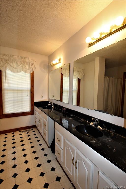 1244 Cameron Road Polkton, NC 28135 - Photo 15 of 19 a large white kitchen with sink a stove and a window