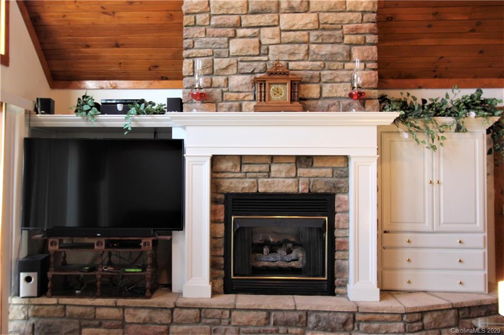 1244 Cameron Road Polkton, NC 28135 - Photo 8 of 19 a living room with a fireplace wooden floor and a potted plant