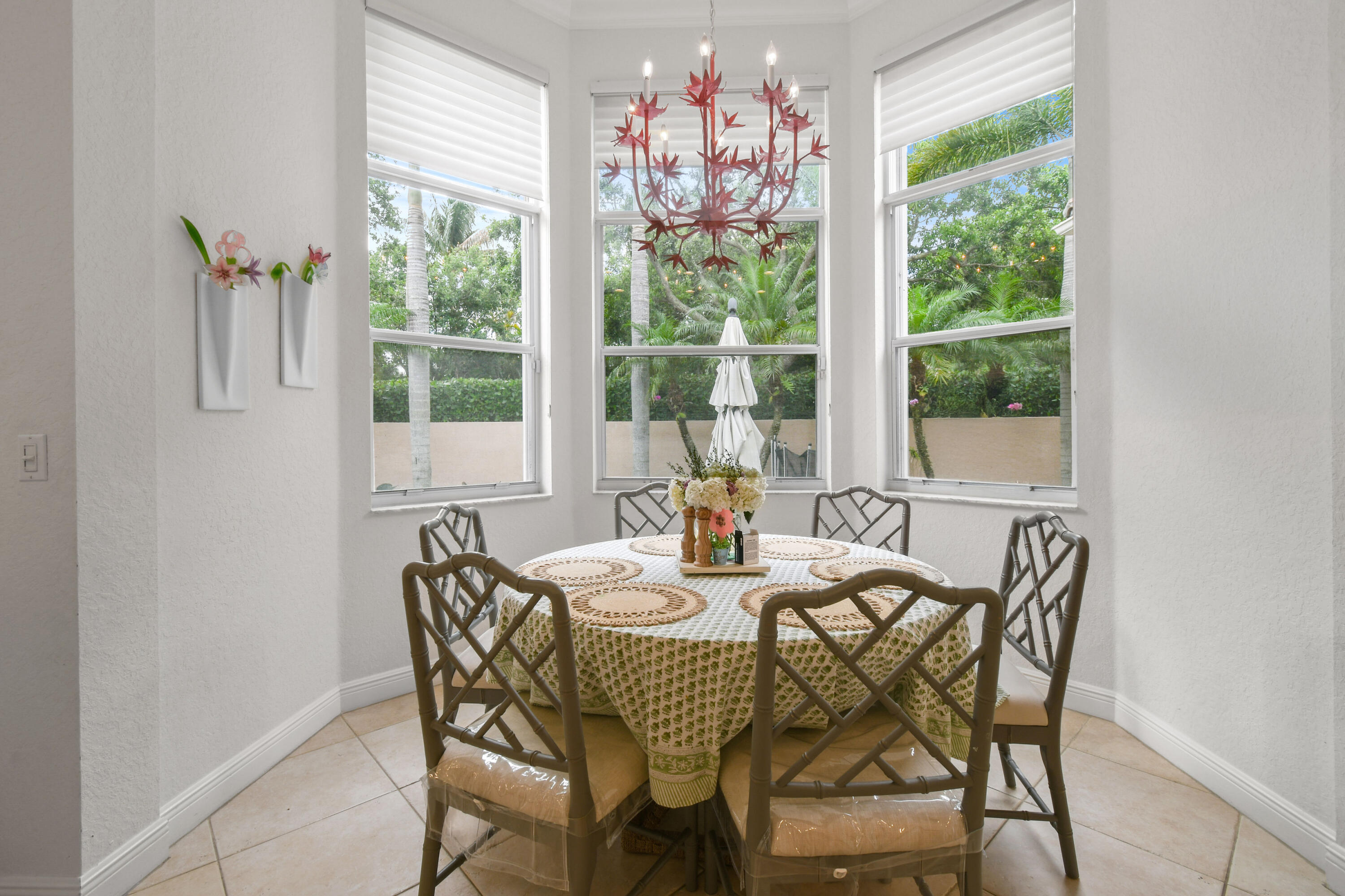 111 Bilboa Drive Jupiter, FL 33458 - Photo 14 of 35 a dining room with furniture large windows and a chandelier