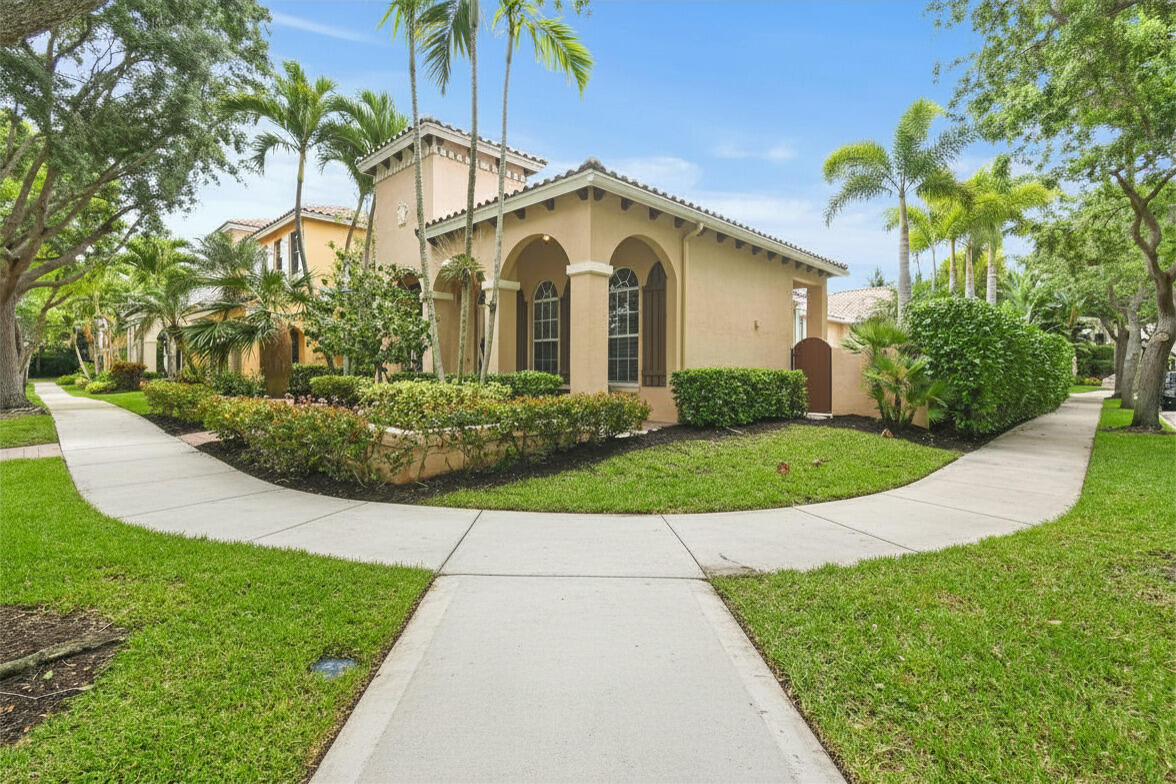 111 Bilboa Drive Jupiter, FL 33458 - Photo 2 of 35 a view of a white house with a small yard and plants